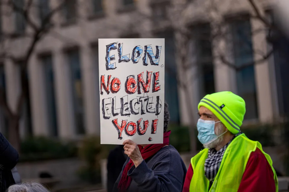 WASHINGTON DC, DISTRICT OF COLUMBIA, UNITED STATES - 2025/02/04: A protester holding a placard gather outside of the United States Office of Personal Management (OPM) headquarters to stand against what they called a 